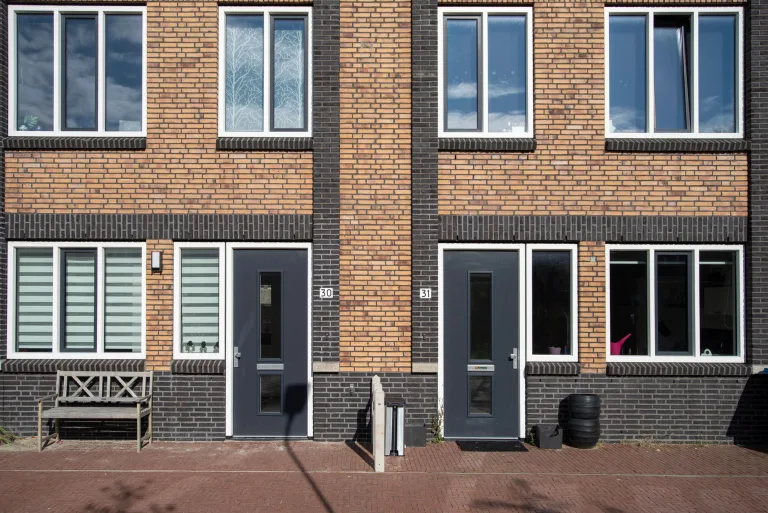 Brick residential facade with coordinated windows and doors
